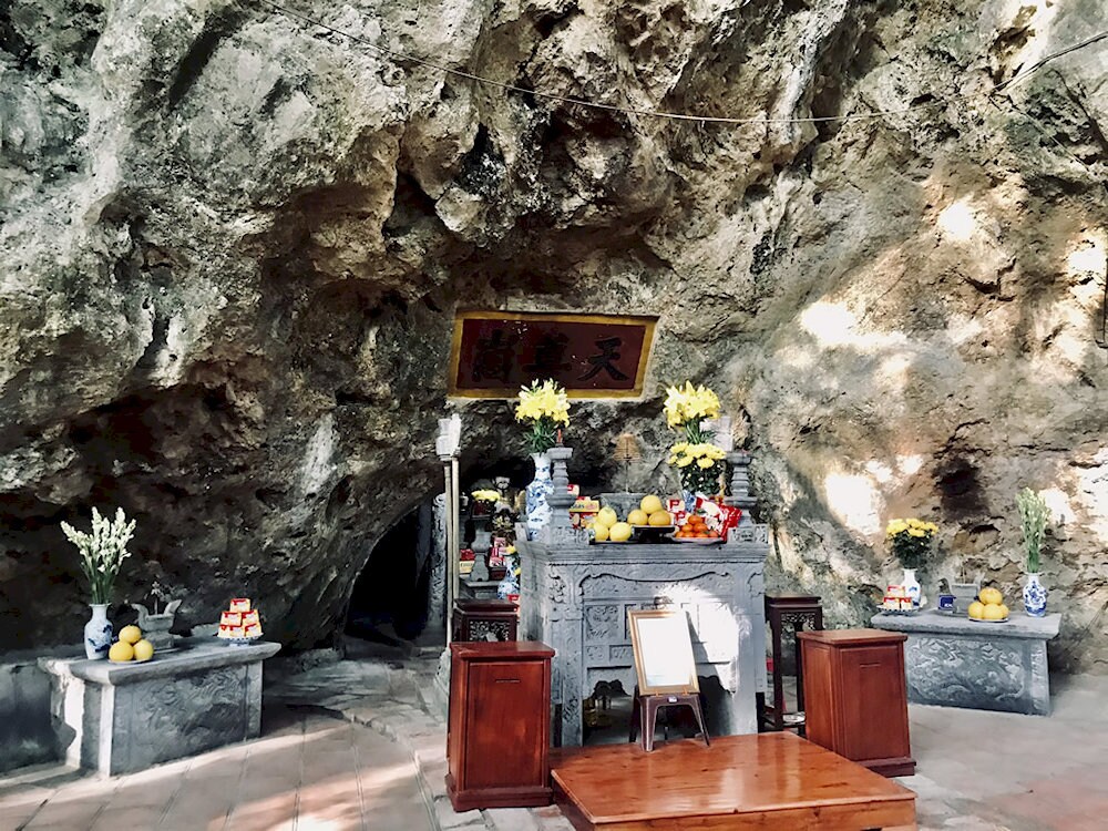 Ancient Buddha statues and carved reliefs glow under the soft light, creating a sacred and tranquil space